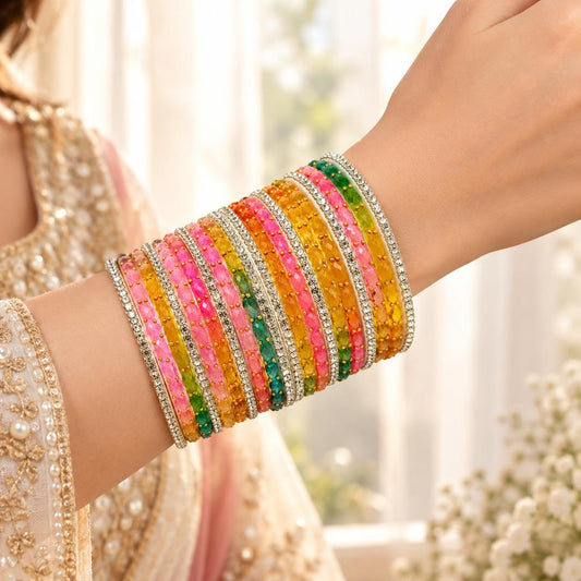 Multicolor crystal bangles set worn on bride's wrist with lehenga
