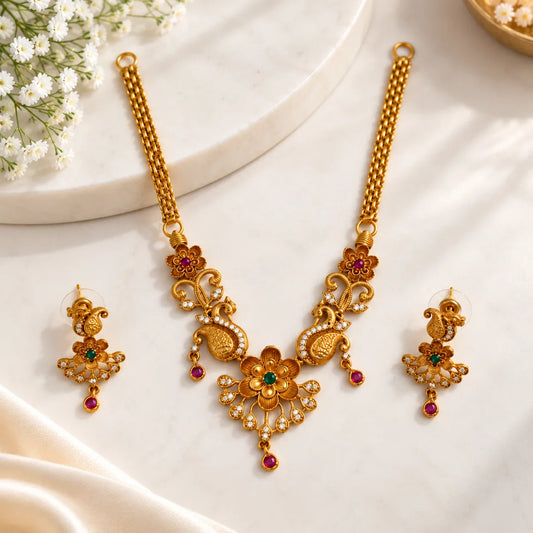 Traditional floral peacock jewellery set on red background