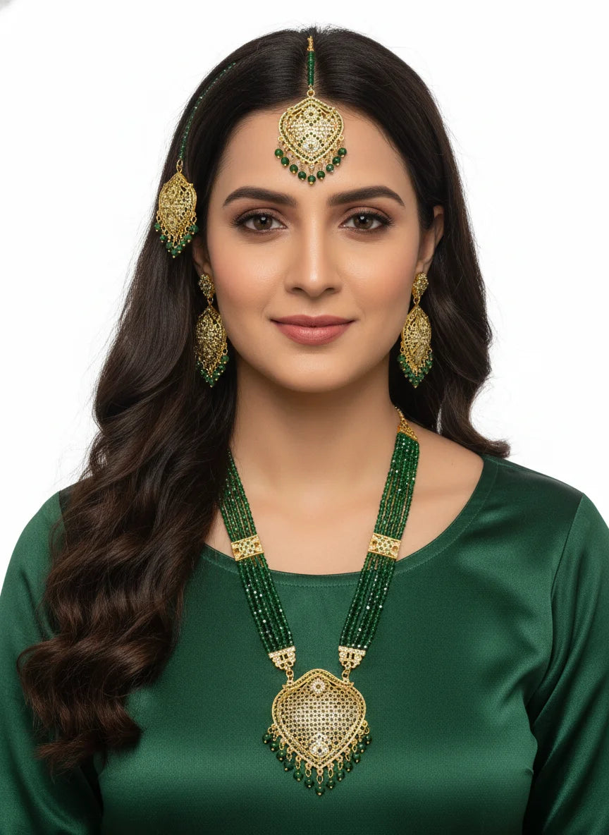 Woman wearing green and gold traditional jewelry on a white background