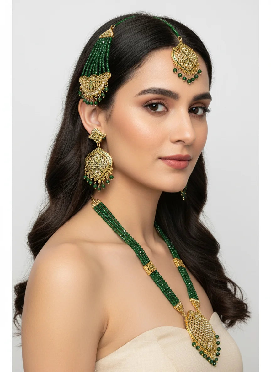 Woman wearing green and gold jewelry set on a white background