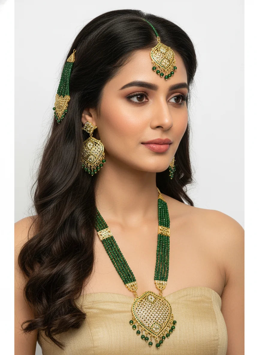 Woman wearing green and gold jewelry set on a white background