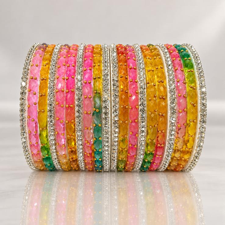 multicolor crystal bangles stack with stone studded borders on mirror surface