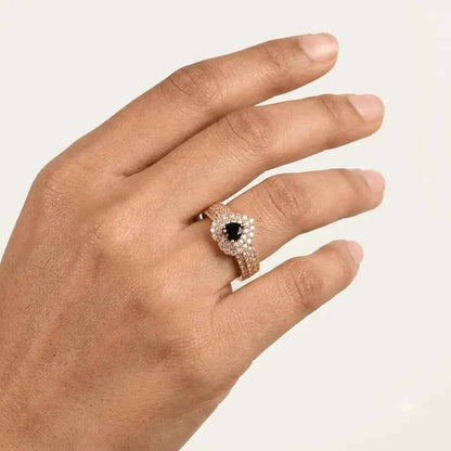 GEHNA OFFICIAL gold plated ring featuring a black heart stone surrounded by sparkling zircon on a woman's finger