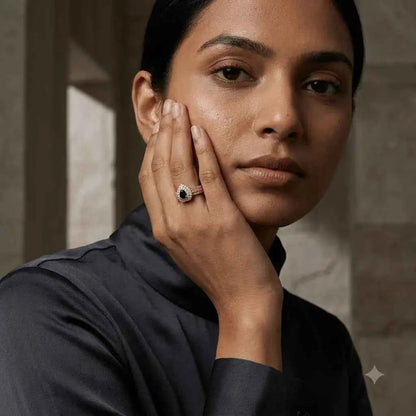 GEHNA OFFICIAL gold plated ring with a black heart stone and zircon halo worn by a woman on her finger