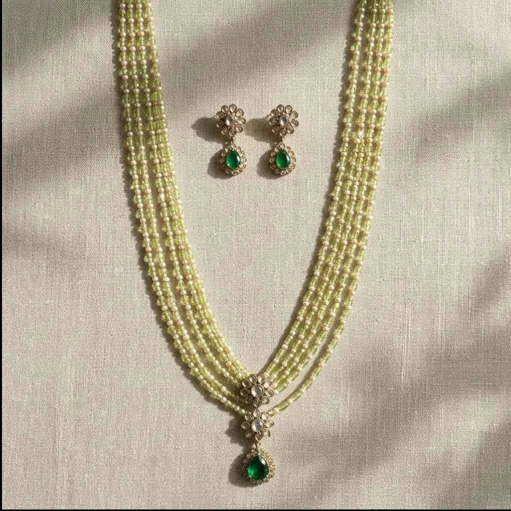 GEHNA OFFICIAL layered necklace set with green and pearl beads, gold tone finish, floral pendant, and matching studs.