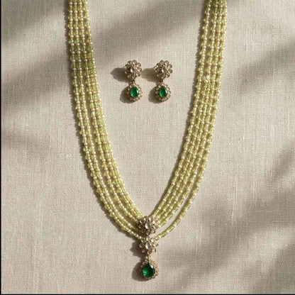 GEHNA OFFICIAL layered necklace set with green and pearl beads, gold tone finish, floral pendant, and matching studs.