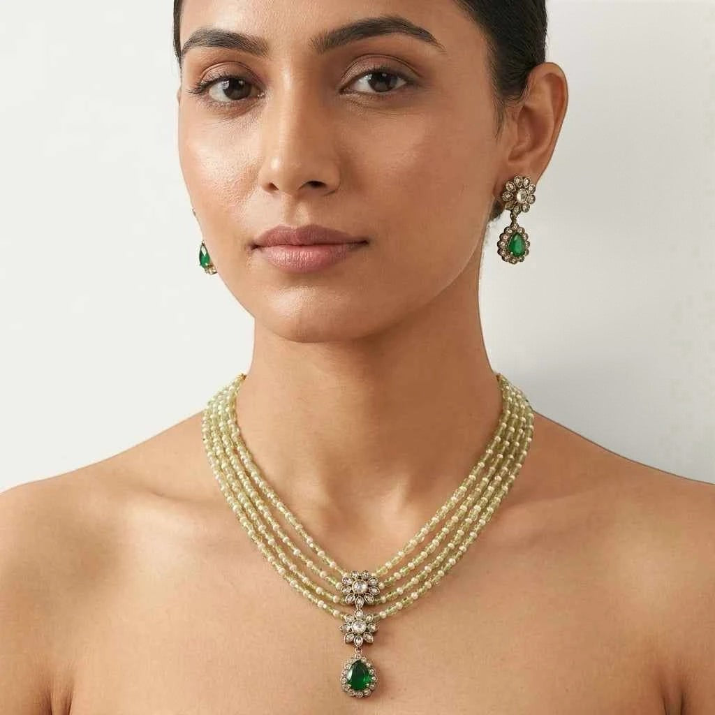 gehna official layered necklace set with green and pearl beads, floral american diamond centerpiece, and earrings.