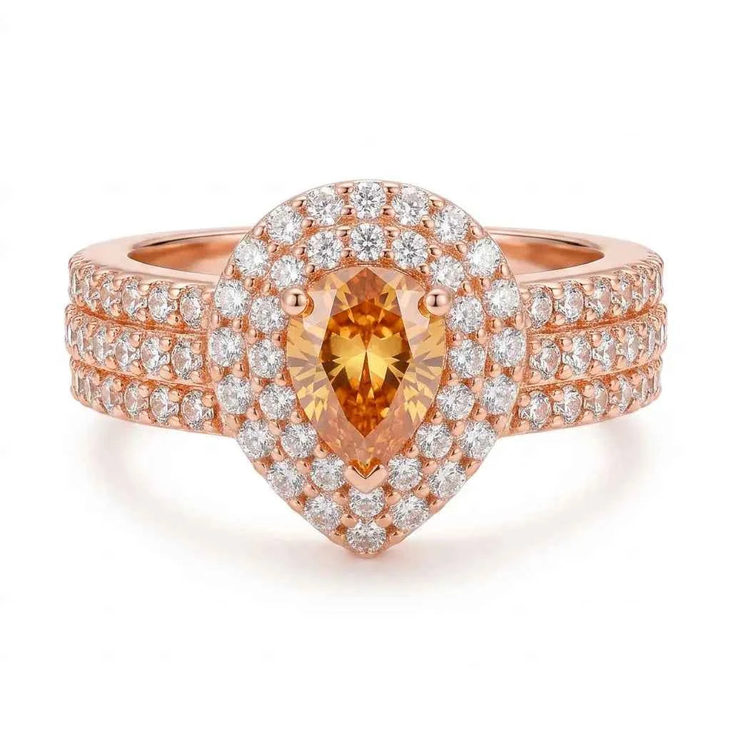 GEHNA OFFICIAL rose gold plated ring featuring a pear-shaped golden stone surrounded by sparkling white zircon stones.