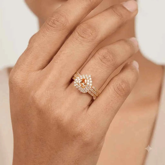 GEHNA OFFICIAL rose gold plated ring featuring a pear shaped golden stone surrounded by sparkling white zircon stones